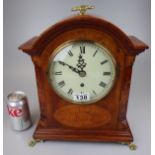 Inlaid mantel clock on brass claw feet