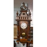 Victorian mahogany wall clock adorned with horse