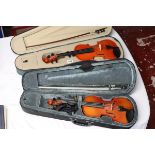 2 cased violins