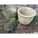 Two stone planters and a stone Otter