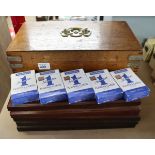 Wooden box containing playing cards and cribbage boards