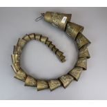 Long string of Egyptian brass camel bells approx length 138cm