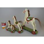 Three graduated wooden rocking horse ornaments