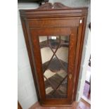 Glazed oak corner cupboard