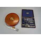 Cased draughtsman's set together with vintage tape measure
