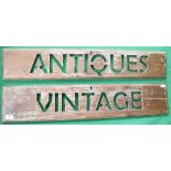 2 wooden signs one saying Antiques and the other Vintage
