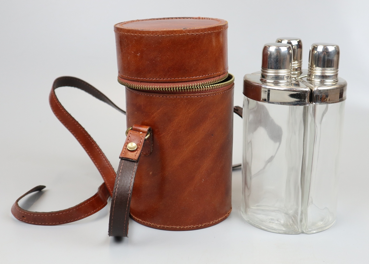 3 hip flasks in leather case