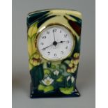 Moorcroft cased small mantel time piece, tube lined with Iris water Lilies on a cream ground. With a