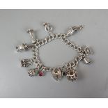 Silver charm bracelet to include 9ct white gold and ruby pendent