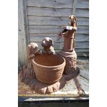 Cast iron water pump featuring puppies