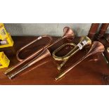 3 copper horns and a brass one