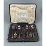 Cased set of silver spoons with tongs