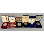 4 silver proof coins including a £1 coin and 2 commemorative medallions