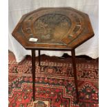 A naively carved octagonal occasional table with Good Luck motif