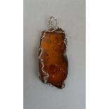 Large amber pendant with silver mount