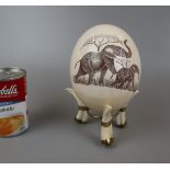 Engraved Ostrich egg on warthog tusk stand - Approx height: 18cm