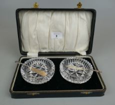 Cased condiment set 2 glass bowls with 2 hallmarked silver knives