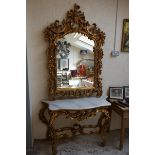 Large gilt mirror with serpentine top together with marble topped gilt hall table