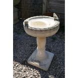 Stone birdbath adorned with birds