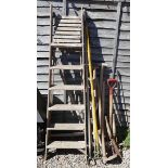 Collection of garden tools and a stepladder