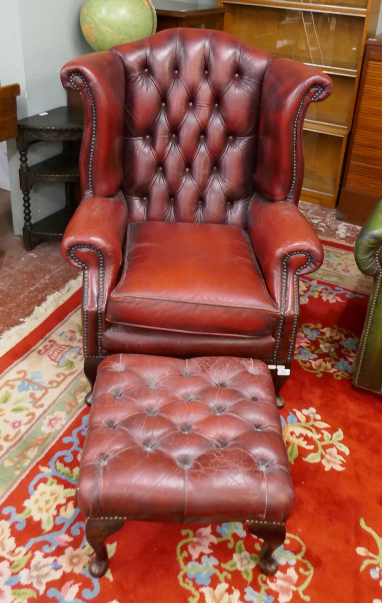 Ox-blood leather wing back chair together with matching stool