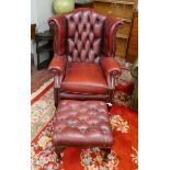 Ox-blood leather wing back chair together with matching stool