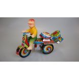 Jaguari man on motorcycle tin plate toy