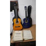 2 guitars together with a collection of vintage sheet music