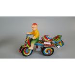 Jaguari man on motorcycle tin plate toy