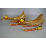 Two novelty wooden ducks on skis