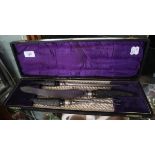 Cased carving set with horn handles and silver collars