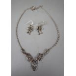 Pair of silver cherub earrings together with silver necklace