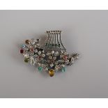 Silver brooch set with gem stones