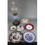 Oil lamp together with a collection of cabinet plates