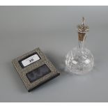 Silver picture frame together with a silver top oil bottle