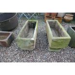 Pair of stone troughs on feet