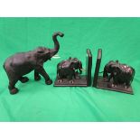 Pair of carved hardwood elephant book ends together with a Libertys style leather elephant figure