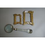 2 Art Nouveau brass photo frames together with a large magnifying glass with cut glass handle