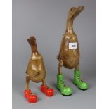 2 wooden ducks in boots