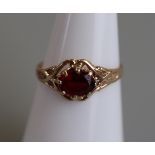 Gold child's garnet set ring - Size J½