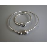 Silver slave bangle together with a matching silver collar