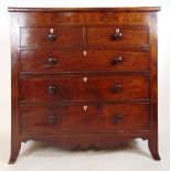 An early 19th century mahogany and strung chest of two short over three long drawers with shaped
