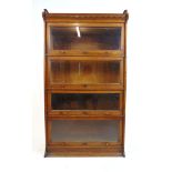 An early 20th century oak sectional bookcase by Lebus, comprising of four glazed bookcase sections,