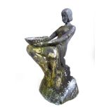 An early 20th century Art Deco lead water feature in the form of a seated nude lady holding a bowl,