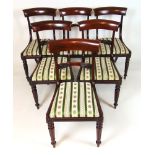 A set of six early 19th century mahogany dining chairs,