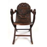 An early 20th century carved teak arm chair attributed to Jubbar Kahn and son of Kashmir,
