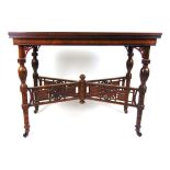 An Edwardian rosewood card table, the fold over top supported on a swivel action on turned,