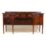 An early 20th century mahogany serpentine front side board in the 18th century style,