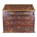 An 18th century and later carved oak bureau,