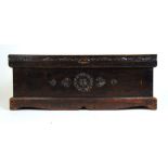 An early 20th century chip carved chest, the top revealing a vacant interior on shaped plinth base,